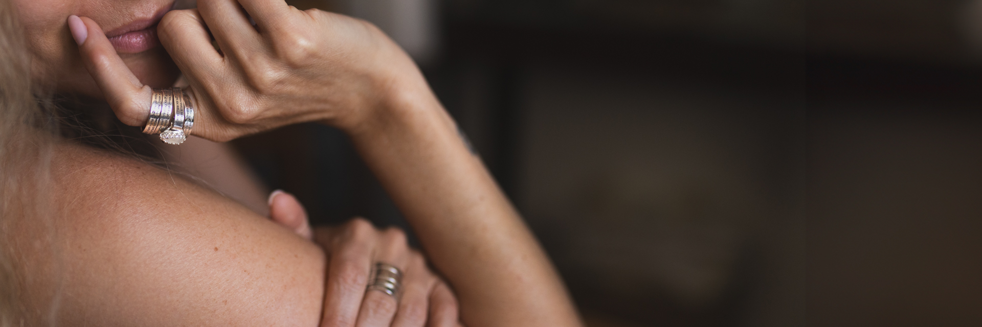 Woman wearing a stack of silver rings with Hebrew engravings - handmade rings for women