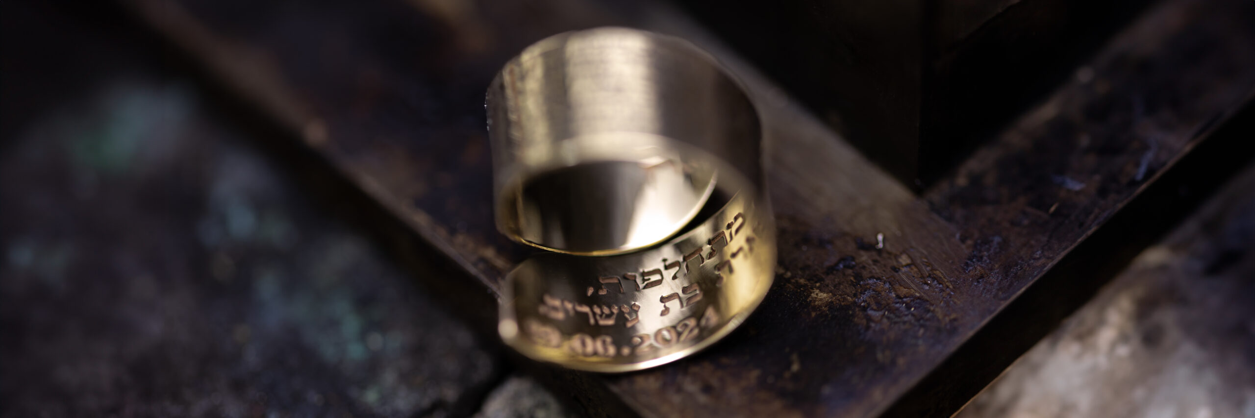 Woman wearing custom engraved solid gold rings – personalized Hebrew jewelry for women