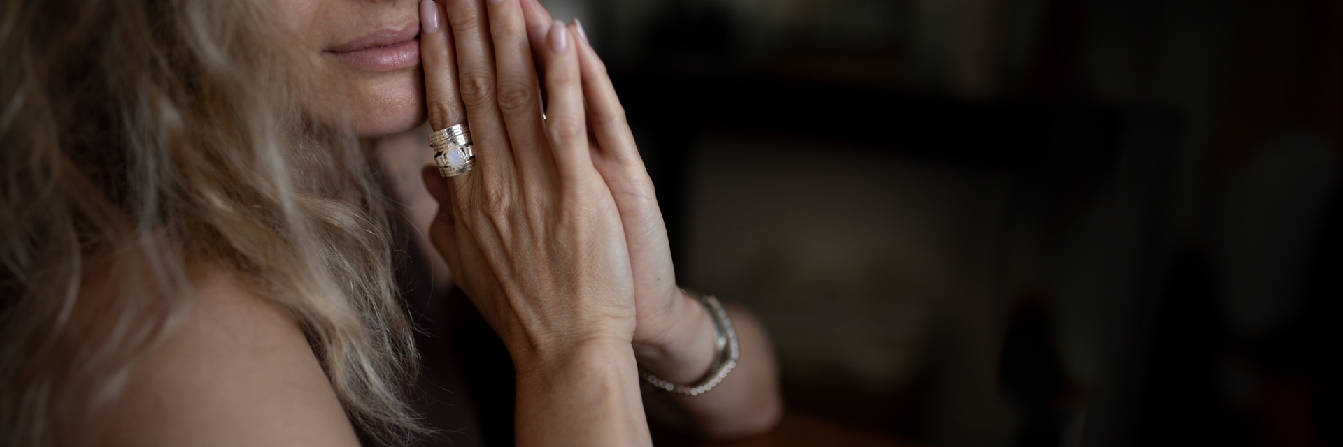 Sterling silver Hebrew engraved ring with gemstone, worn on a woman's hand in a romantic pose